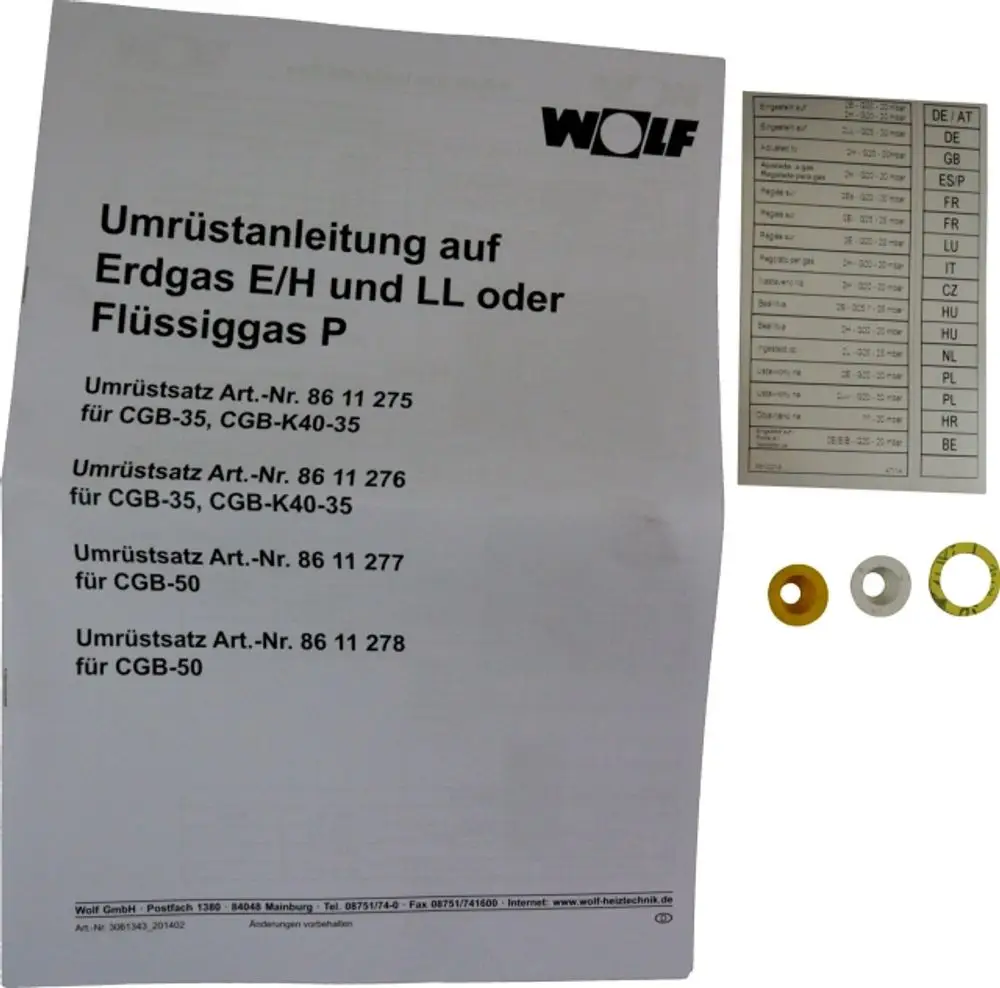 Wolf Umrüstsatz mit Montageanleitung für den Wechsel von Erdgas auf Flüssiggas, einschließlich verschiedenfarbiger Ringe für unterschiedliche Modelle.